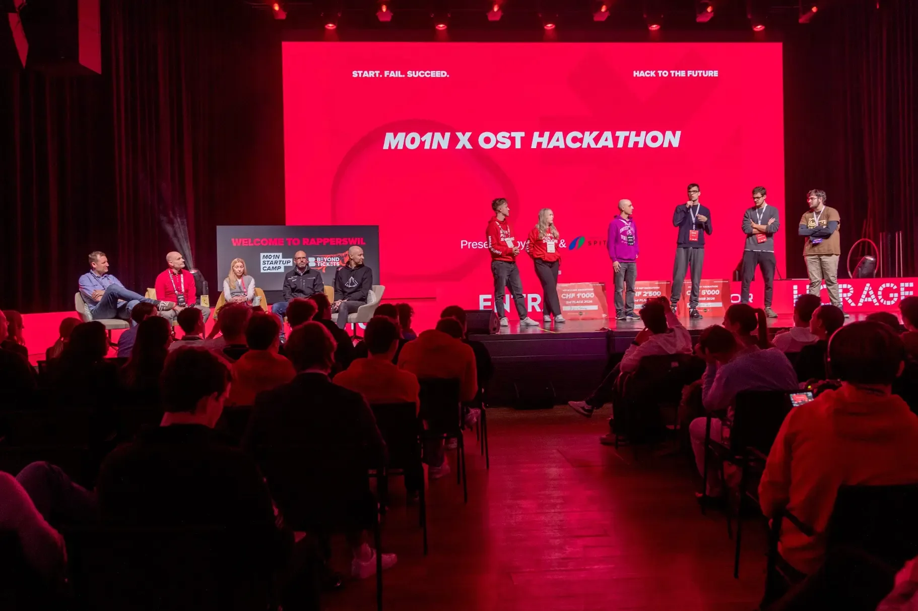 M01N x OST Hackathon participants and jury together on stage in Rapperswil